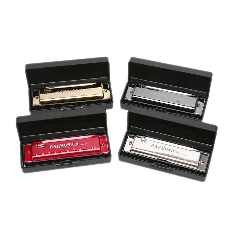 Four harmonicas in black cases on a white background