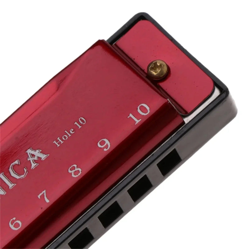 Close-up of a red harmonica with 'Hohner' branding on a white background