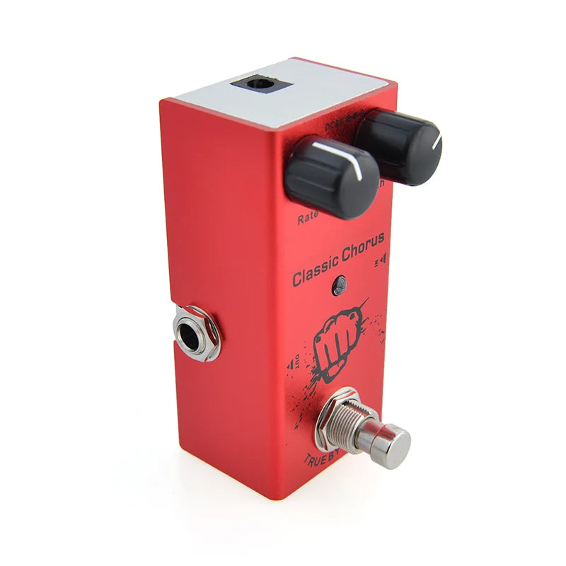 Red guitar effects pedal with black knobs on a white background