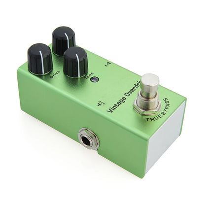 Green guitar effects pedal with knobs and switch on a white background
