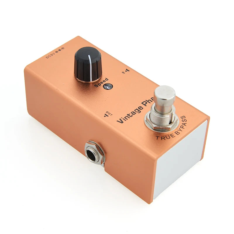 Orange guitar effects pedal with control knobs and True Bypass switch on a white background