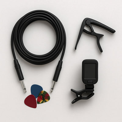 Guitar accessories including a cable, tuner, and picks on a white background